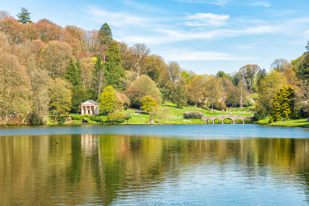 istock Stunning Country Park with Stone Bridge and Lake 1220409052