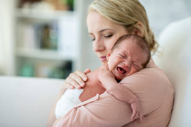 mother and newborn son - colic imagens e fotografias de stock