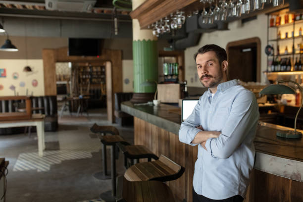 istock Public institutions closed due to COVID-19 or Coronavirus outbreak lockdown, stressed owner of small business alone in his cafe, restaurant, bar 1220409843