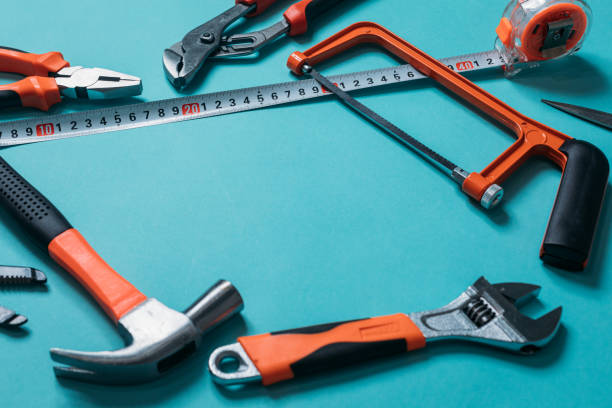 istock group bunch of tools with orange handles on a blue background close 1220411739