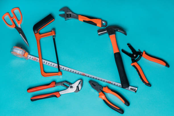 istock group bunch of tools with orange handles on a blue background close 1220411785