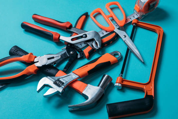 istock group bunch of tools with orange handles on a blue background close 1220411824