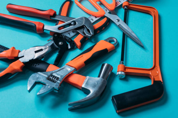 istock group bunch of tools with orange handles on a blue background close 1220411857
