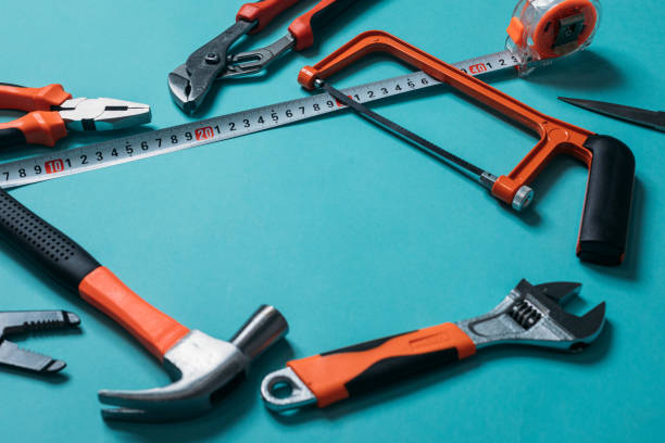 istock group bunch of tools with orange handles on a blue background close 1220411886