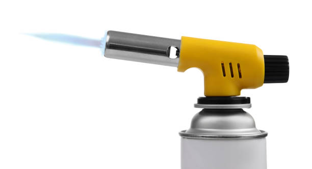 istock Manual gas torch burner on spray can with blue flame on white 1220413114