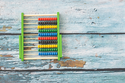 Toys: Wooden abacus isolated on old blue wooden background