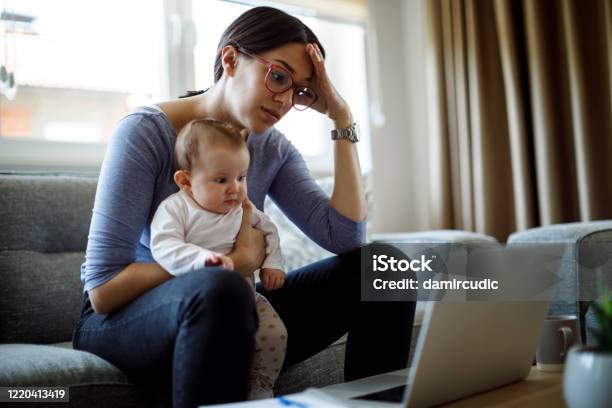 Tired Young Mother Working From Home Stock Photo - Download Image Now - Mother, Financial Bill, Family