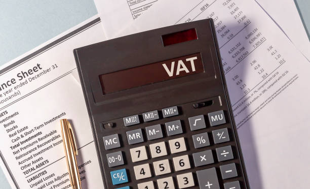 istock VAT word on display of calculator on papers documents and golden pen 1220414024