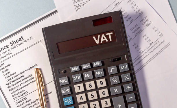 VAT word on display of calculator on papers documents and golden pen VAT word on display of calculator on papers documents and golden pen vat stock pictures, royalty-free photos & images
