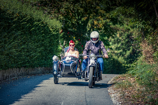 Bride Getting Transported To Wedding Ceremony in an Old-fashioned Sidecar Motorcycle.