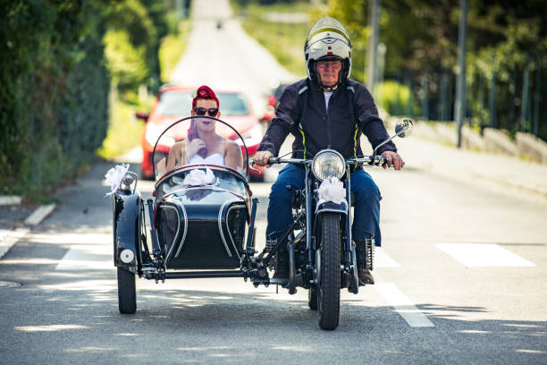 Bride Riding To Wedding Ceremony in an Old Sidecar Motorcycle Bride Riding To Wedding Ceremony in an Old Sidecar Motorcycle. sidecar photos stock pictures, royalty-free photos & images