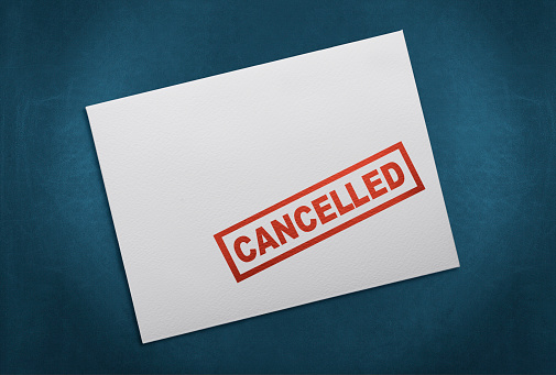 Cancelled Stamp On White Envelope. Isolated on Blue Background