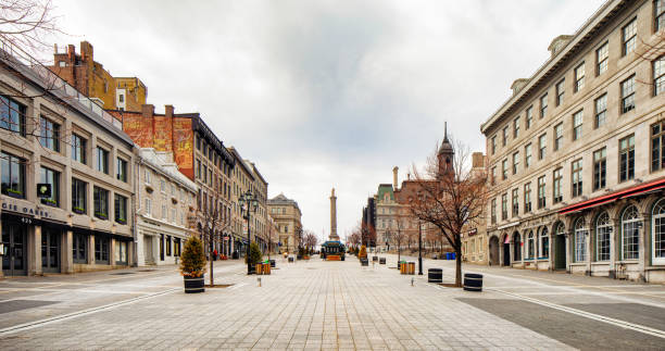 Montreal deserted place Jacques-Cartier on a cloudy Springtime day panoramic view Montreal deserted place Jacques-Cartier on a cloudy Springtime day. This spot, usually teeming with tourists is left empty due due to covid 19 and home stay directives. old montreal city hall stock pictures, royalty-free photos & images