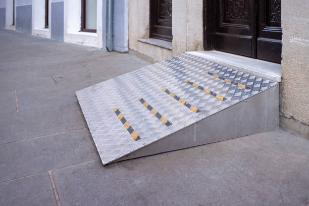 Building entrance with ramp Ramp for disabled persons on wheelchair at building entrance. pebble driveway stock pictures, royalty-free photos & images