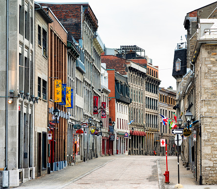 Deserted Old Montreal street scene on a cloudy Springtime day. This spot, usually teeming with tourists is left empty due due to Covid 19 and home stay directives.