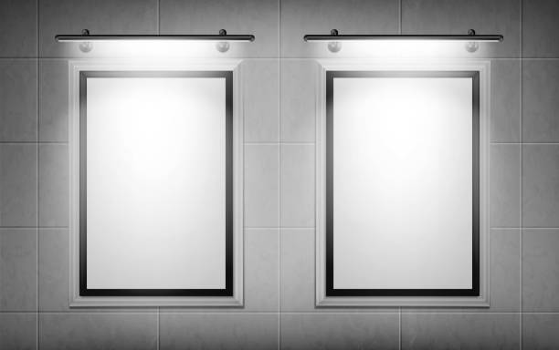 Blank movie posters illuminated by spotlights Blank movie posters illuminated by spotlights. Vector realistic mockup of white picture frames on gray tiled wall in cinema, theater or gallery. Empty advertising banners with black border and lamps movie borders stock illustrations