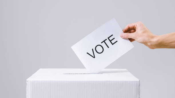 istock Casting vote into the ballot box 1220421420