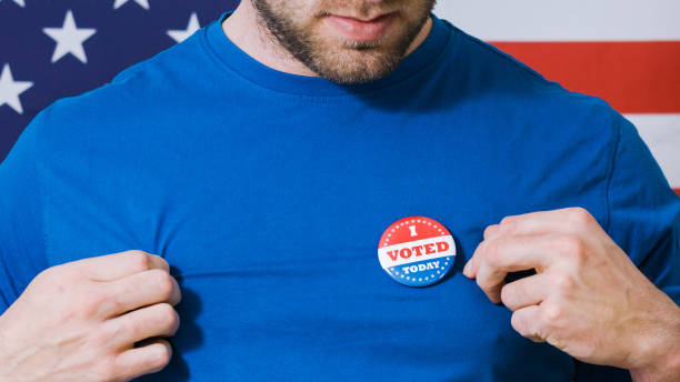 istock Presidential election button on a man 1220421443
