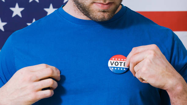 istock Presidential election button on a man 1220421465