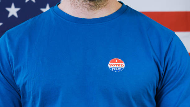istock Presidential election sticker on a man 1220421470