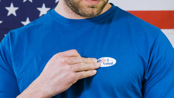 istock Presidential election sticker on a man 1220421492