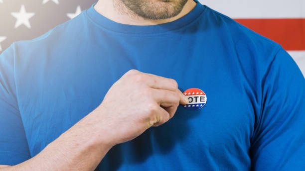 istock Presidential election sticker on a man 1220421512