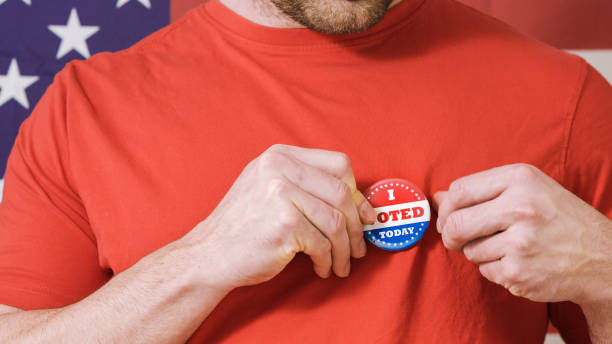 istock Presidential election button on a man 1220421513