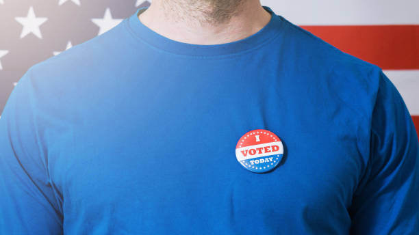 istock Presidential election button on a man 1220421529
