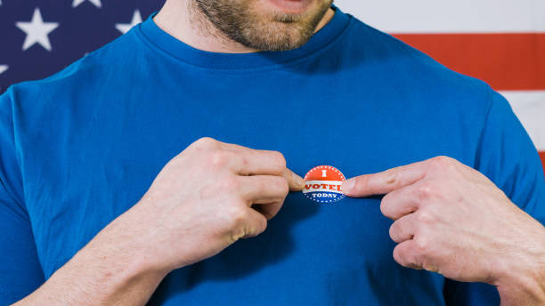 istock Presidential election sticker on a man 1220421582