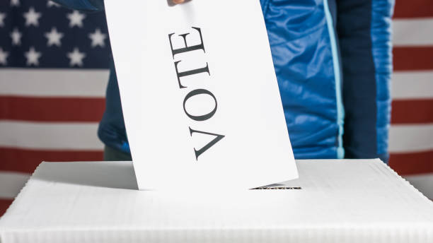 istock Voting woman with American flag 1220421597
