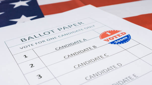 istock Hand put I Voted Today sticker on ballot paper 1220421602