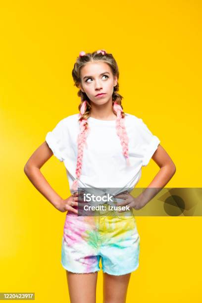 Teenage Girl On Yellow Background Looking Away Stock Photo - Download Image Now - Party - Social Event, Pink Hair, Adolescence