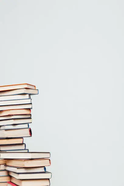 Photo of a lot of stacks of educational books in the library on a white background