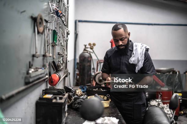 Man Working With Tablet In Auto Repair Stock Photo - Download Image Now - Owner, Mechanic, Auto Repair Shop