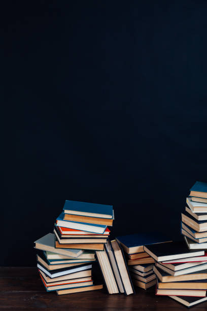 istock many stacks of educational books in the university library on a black background 1220427930