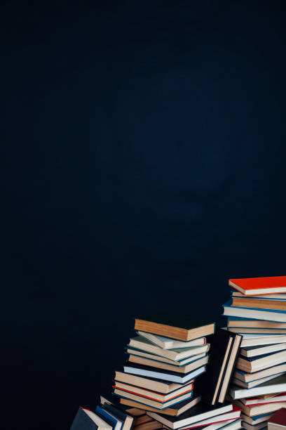 istock many stacks of educational books in the university library on a black background 1220427971