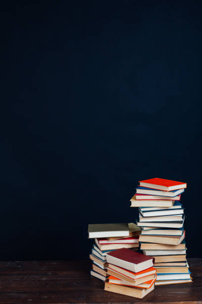 istock many stacks of educational books in the university library on a black background 1220428066
