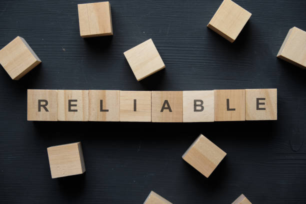 istock Modern business buzzword - reliable. Top view on wooden table with blocks. Top view. 1220429451