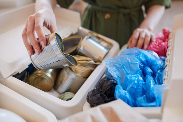 istock Woman Sorting tTash at Home Close Up 1220429848