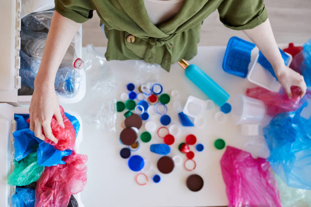 istock Woman Sorting Plastic at Home Above View 1220429882