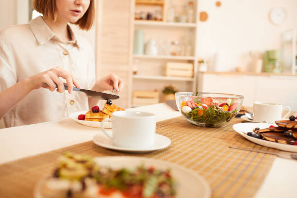 istock Woman Enjoying Delicious Desserts in Cozy Kitchen 1220430582