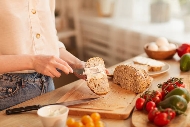 istock Young Woman Making Sandwiches for Breakfast 1220430597