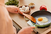 istock Woman Frying Eggs for Breakfast 1220430606
