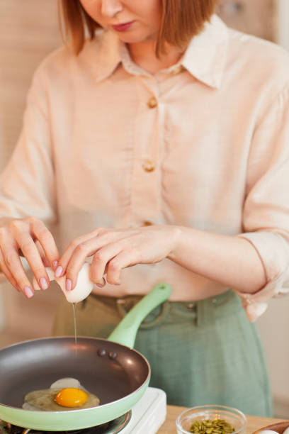 istock Woman Cooking Eggs for Breakfast 1220430609