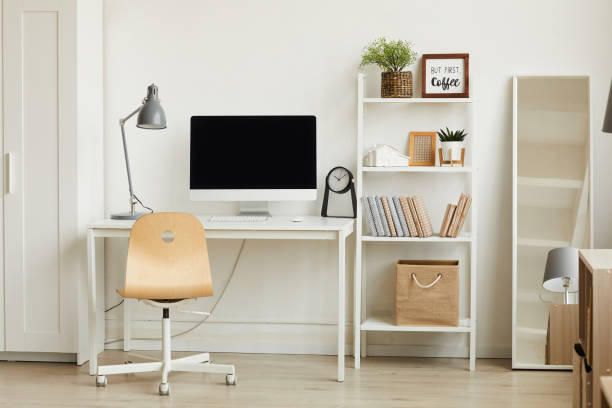 Work Desk in Modern Apartment Clean background image of minimalistic apartment interior with focus on computer desk against white wall, copy space college dorm photos stock pictures, royalty-free photos & images