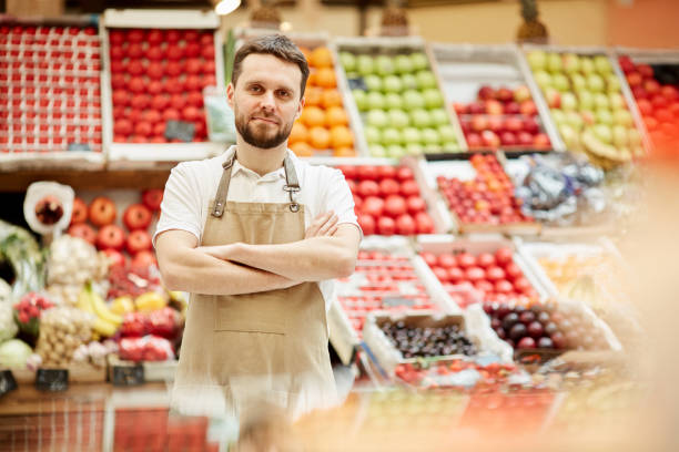 istock Farmer Posing at Market Stand 1220431016