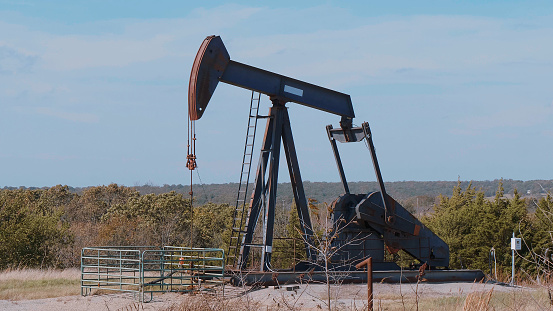Oil pump in the countryside of Oklahoma - Pump jack - USA 2017