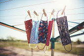Self-sewn mouth-nose masks against corona viruses hang on the clothesline to dry.