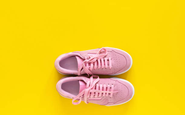 istock Pink sneakers isolated on a yellow background 1220435639
