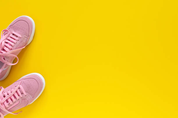 istock Pink sneakers isolated on a yellow background 1220435643